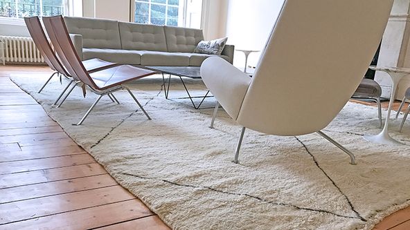 Image may contain: Home Decor, Rug, Chair, Furniture, Couch, Table, Floor, and Flooring