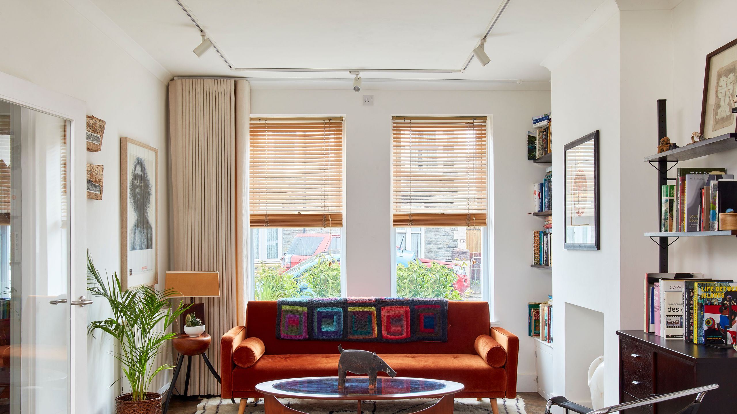 Image may contain: Home Decor, Plant, Couch, Furniture, Chair, Rug, Art, Painting, Lamp, Architecture, Building, and Indoors