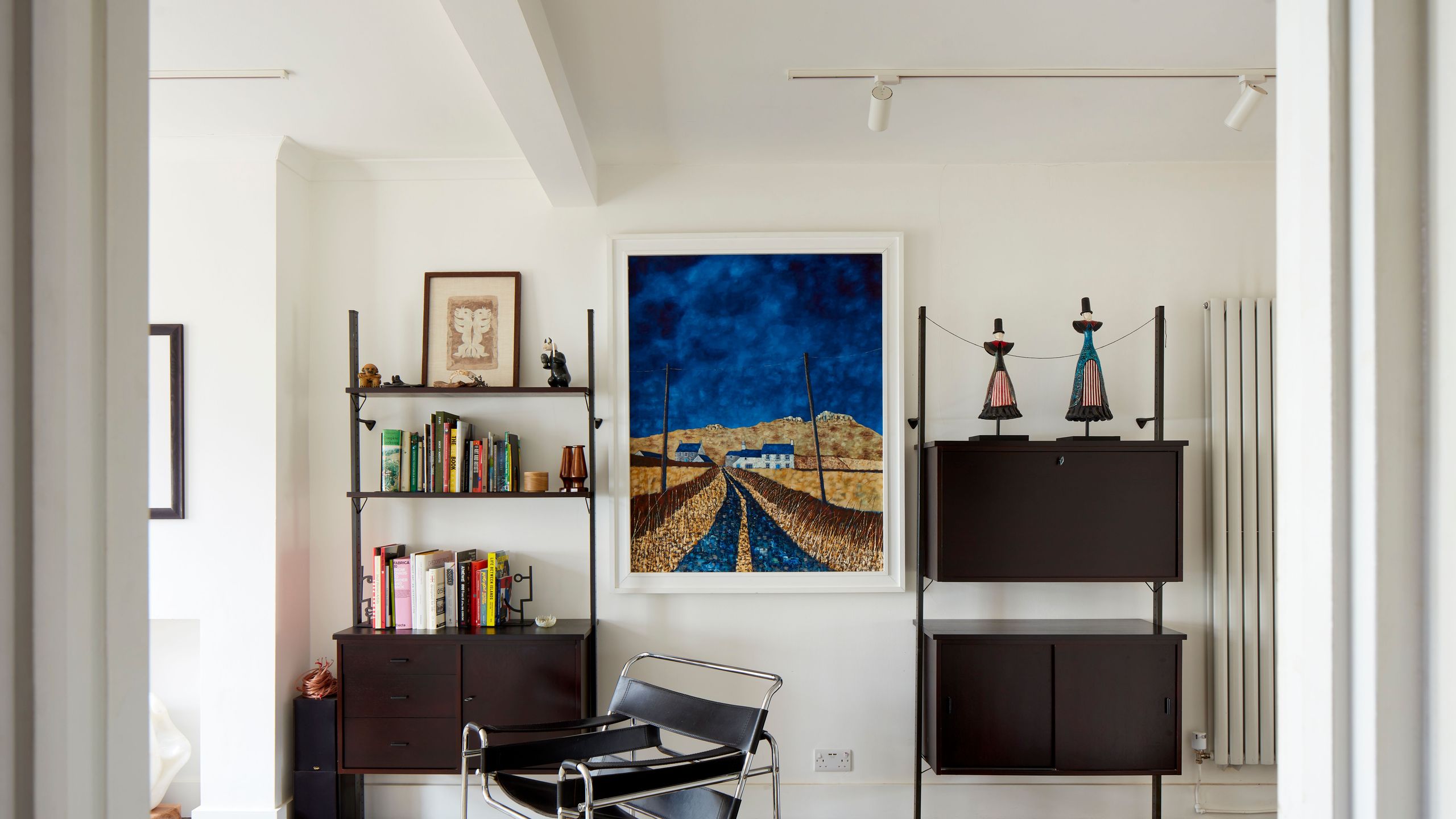 Image may contain: Home Decor, Indoors, Interior Design, Floor, Rug, Flooring, Chair, Furniture, Art, Painting, and Person