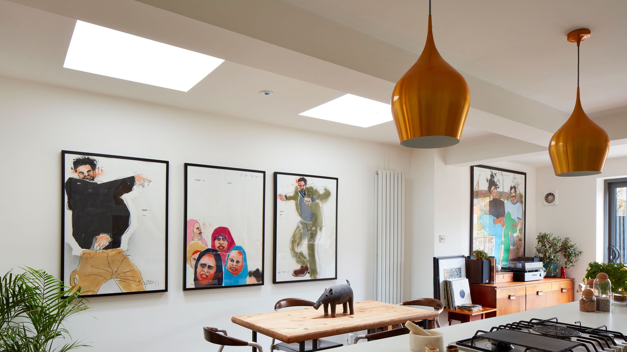 Image may contain: Indoors, Interior Design, Plant, Lamp, Cooktop, Kitchen, Art, Painting, Chair, Furniture, and Home Decor