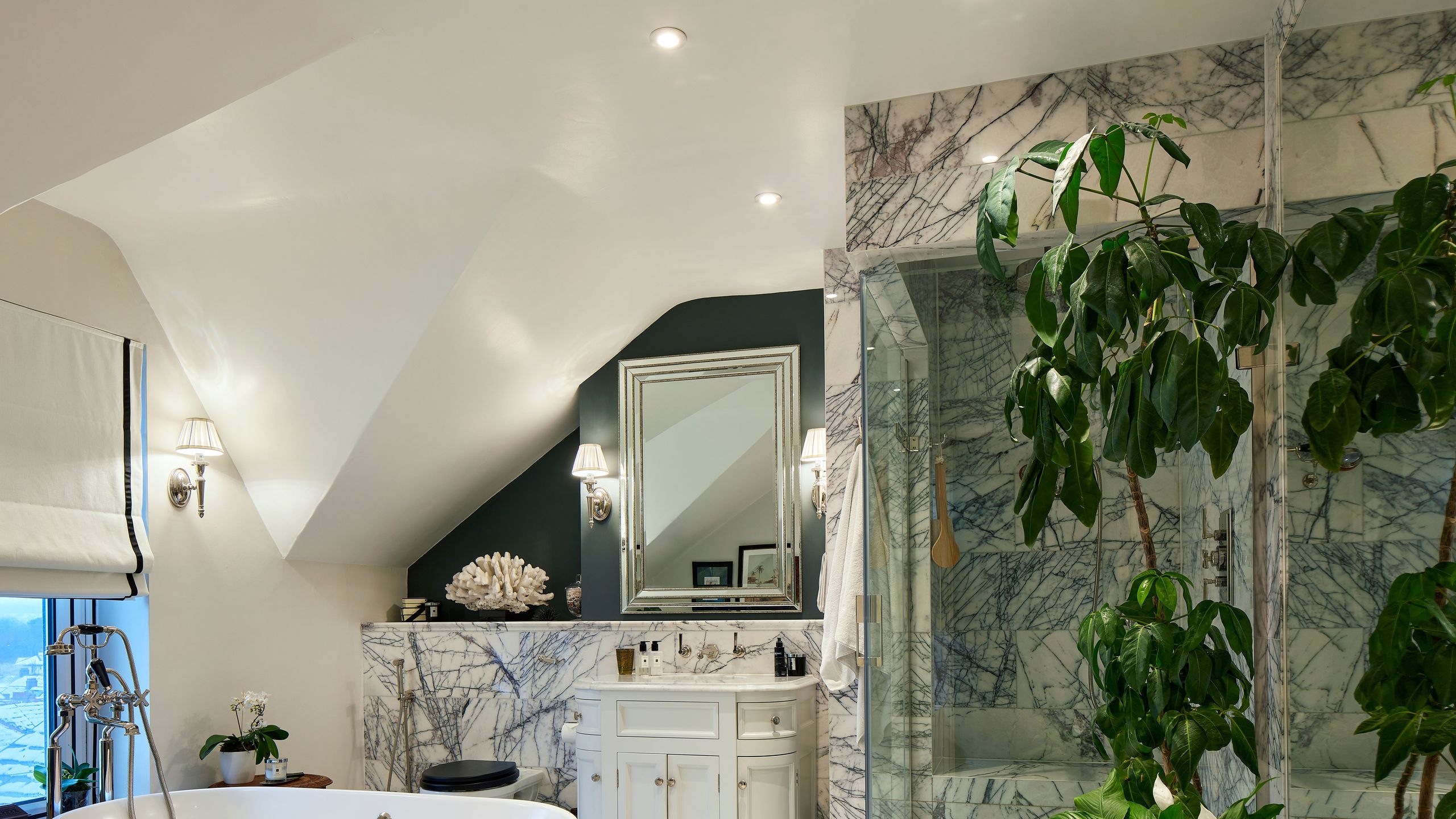 Image may contain: Floor, Lamp, Indoors, Interior Design, Plant, Bathing, Bathtub, Person, Tub, Flooring, and Potted Plant