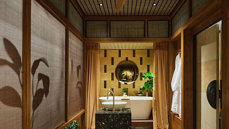 Image may contain: Indoors, Interior Design, Sink, Plant, Bathing, Bathtub, Person, Tub, Sink Faucet, and Wood