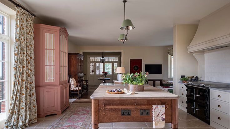 Image may contain: Home Decor, Chair, Furniture, Lamp, Indoors, Interior Design, Kitchen, Desk, Table, and Plant