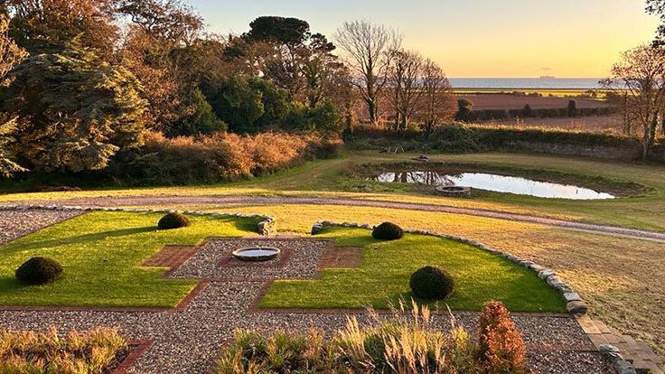 Image may contain: Outdoors, Grass, Nature, Park, Plant, Architecture, Building, Housing, Aerial View, Chair, and Furniture