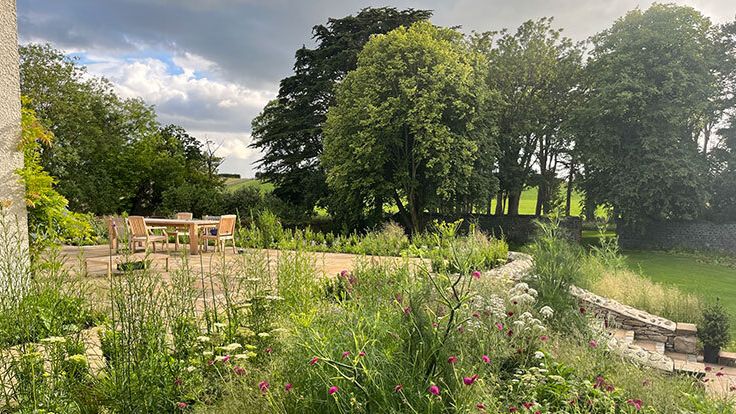 Image may contain: Garden, Nature, Outdoors, Grass, Plant, Park, Vegetation, Scenery, Backyard, Yard, Chair, and Furniture