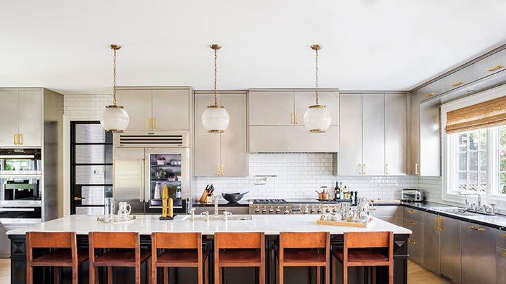 Image may contain: Indoors, Kitchen, Kitchen Island, Interior Design, Chair, Furniture, and Cooktop