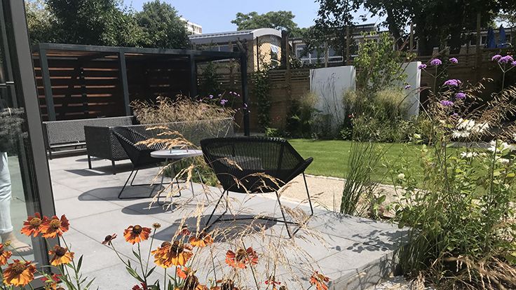 Image may contain: Backyard, Nature, Outdoors, Yard, Garden, Chair, Furniture, Desk, Table, Architecture, Building, and House