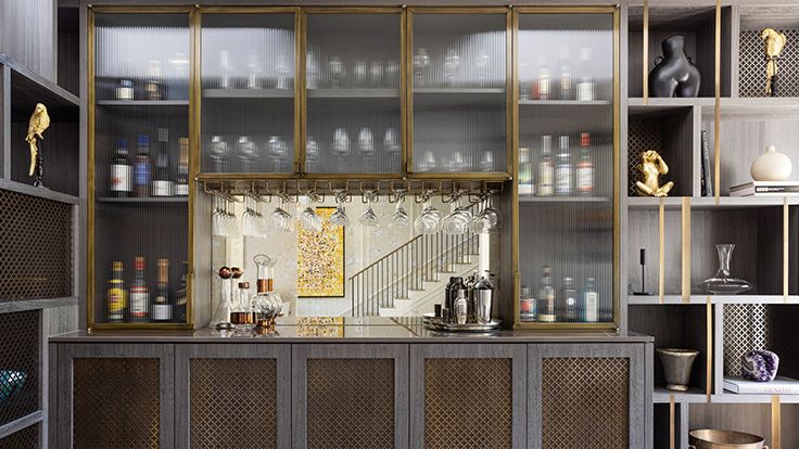 Image may contain: Cabinet, Furniture, Indoors, Interior Design, Shelf, Closet, Cupboard, Person, Sideboard, and Kitchen