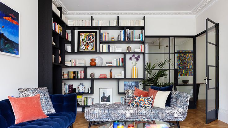 Image may contain: Furniture, Couch, Architecture, Building, Indoors, Living Room, Room, Home Decor, Table, Art, and Painting