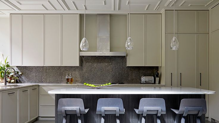 Image may contain: Indoors, Interior Design, Kitchen, Kitchen Island, Chair, Furniture, Lamp, Sink, and Sink Faucet