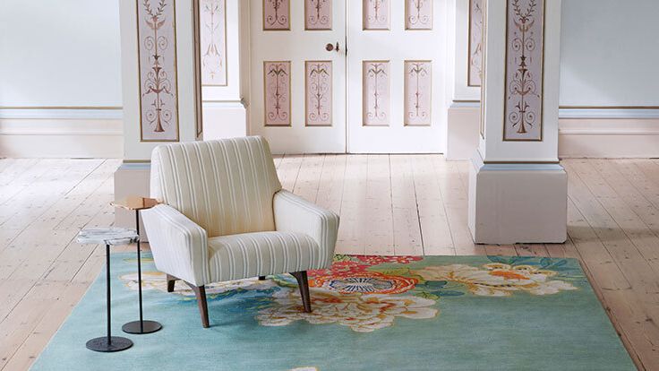 Image may contain: Home Decor, Rug, Chair, Furniture, Art, and Painting