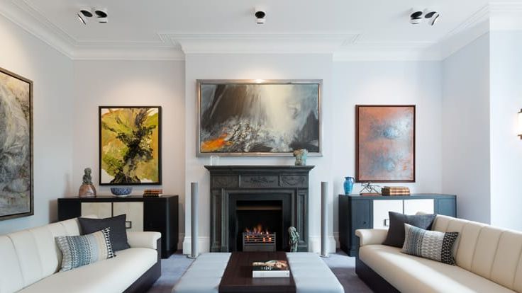 Image may contain: Fireplace, Indoors, Home Decor, Architecture, Building, Furniture, Living Room, Room, Couch, and Art