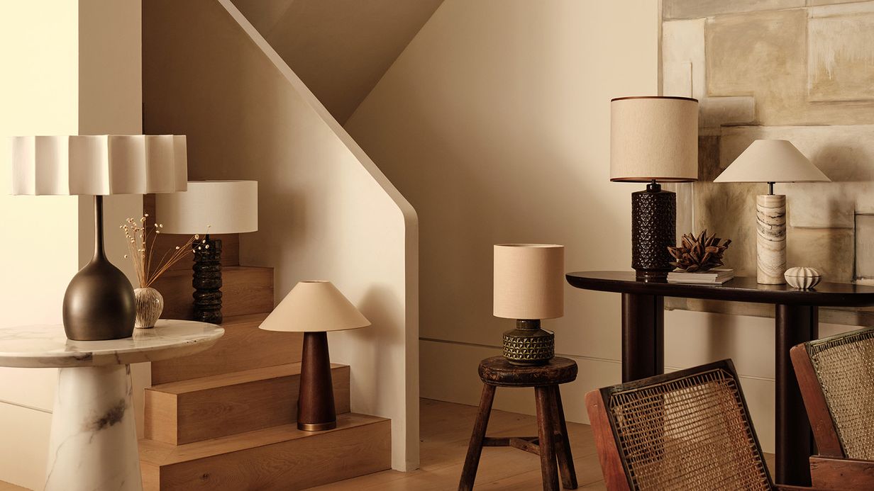 Image may contain: Lamp, Table Lamp, Chair, Furniture, Desk, Table, Architecture, Building, House, Housing, and Staircase