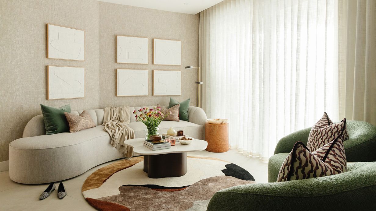 Image may contain: Home Decor, Furniture, Architecture, Building, Indoors, Living Room, Room, Couch, Table, and Cushion