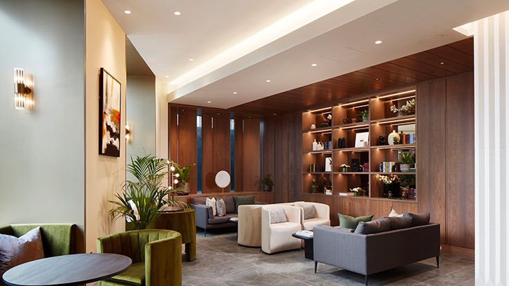 Image may contain: Plant, Couch, Furniture, Indoors, Interior Design, Desk, Table, Home Decor, Architecture, and Building