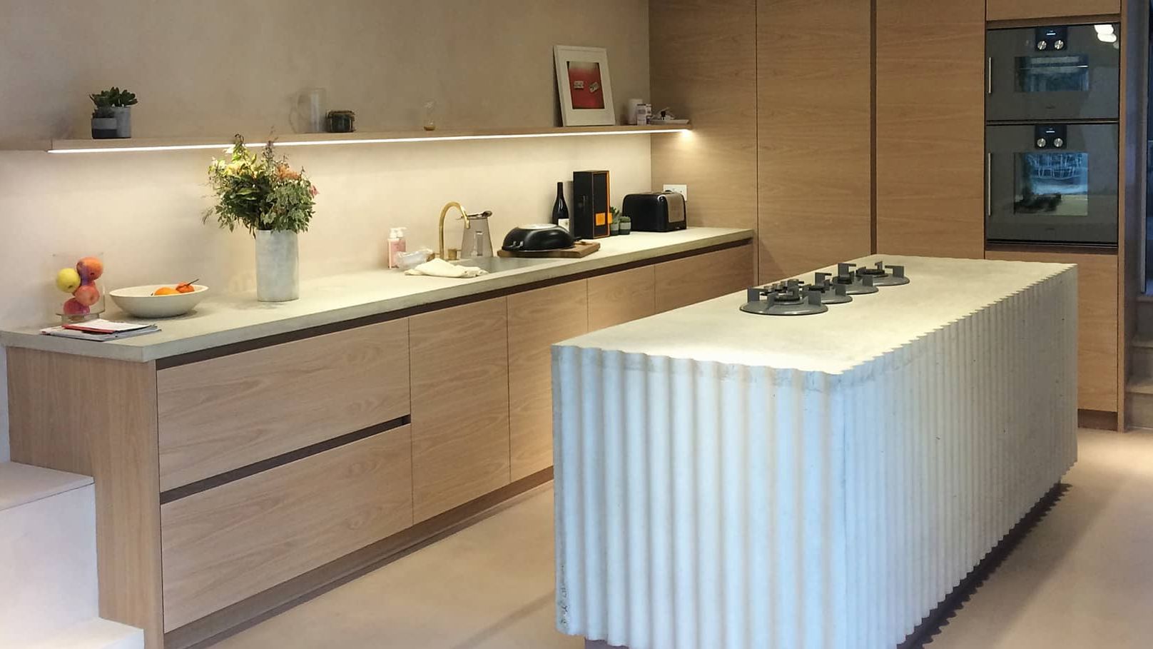 Image may contain: Indoors, Kitchen, Interior Design, Plant, Kitchen Island, Sink, Sink Faucet, Art, and Painting