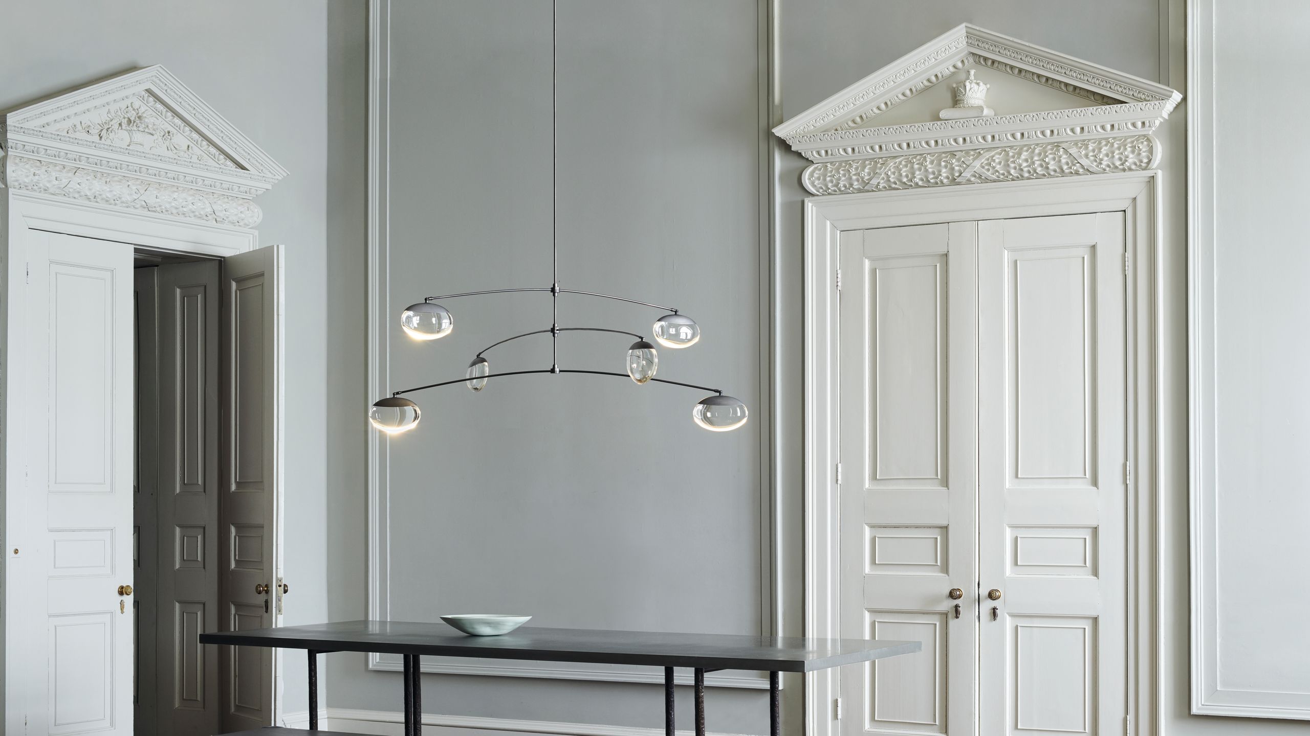 Image may contain: Indoors, Interior Design, Bench, Furniture, Chandelier, Lamp, Dining Table, Table, and Architecture