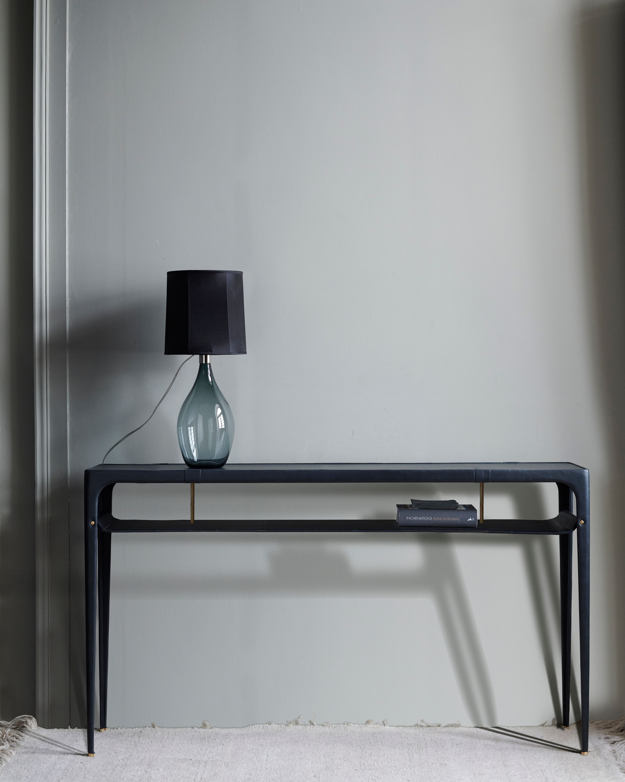 Image may contain: Lamp, Furniture, Table, Table Lamp, and Desk