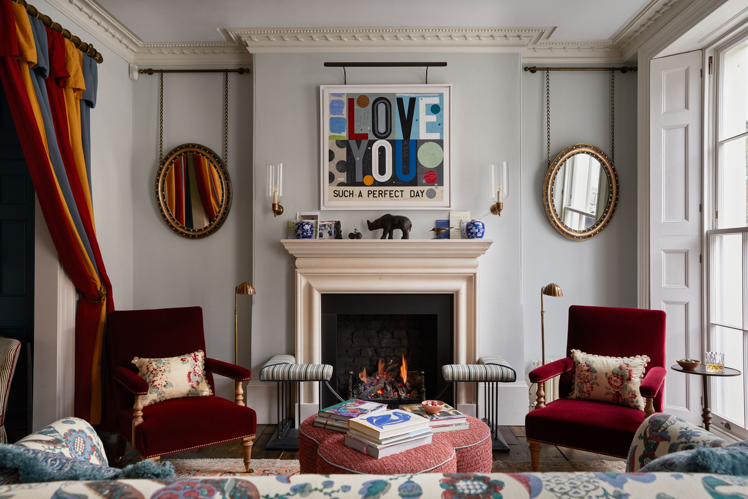 Image may contain: Home Decor, Fireplace, Indoors, Chair, Furniture, Cushion, Desk, Table, Architecture, and Building