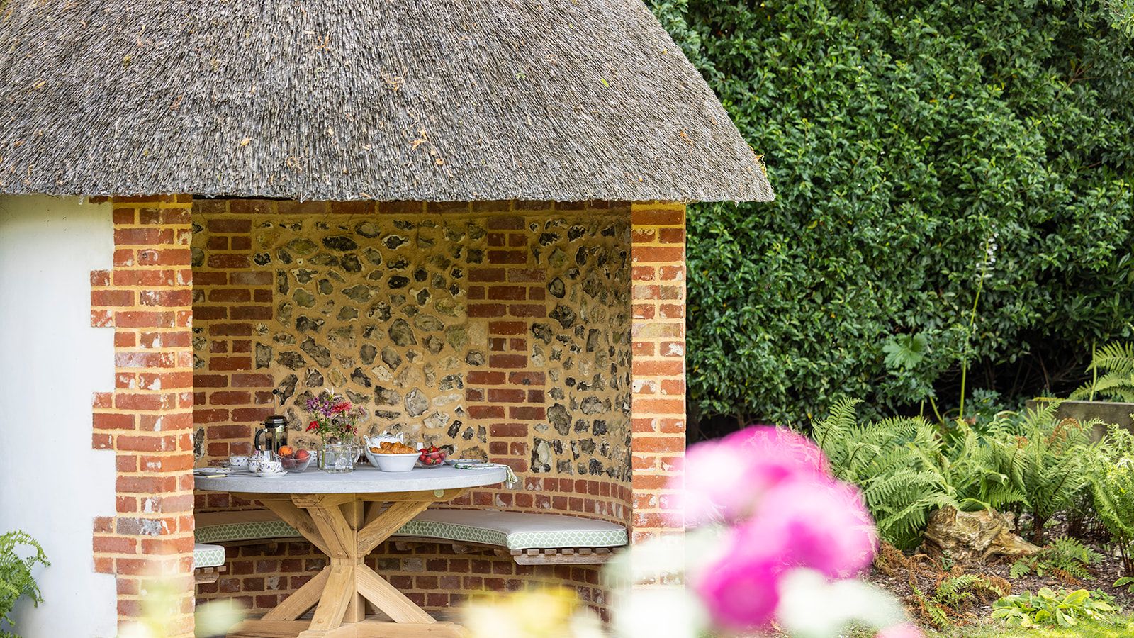 Image may contain: Indoors, Interior Design, Desk, Furniture, Table, Outdoors, Garden, Nature, Grass, Plant, and Architecture