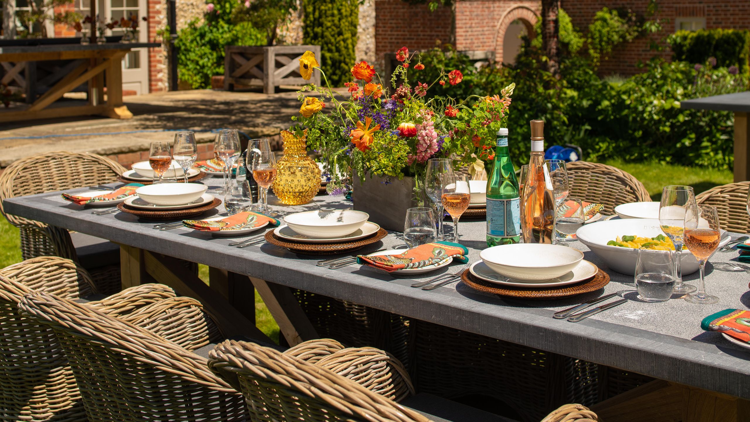 Image may contain: Furniture, Table, Tabletop, Dining Table, Cup, Outdoors, Nature, Plate, Countryside, Chair, and Rural