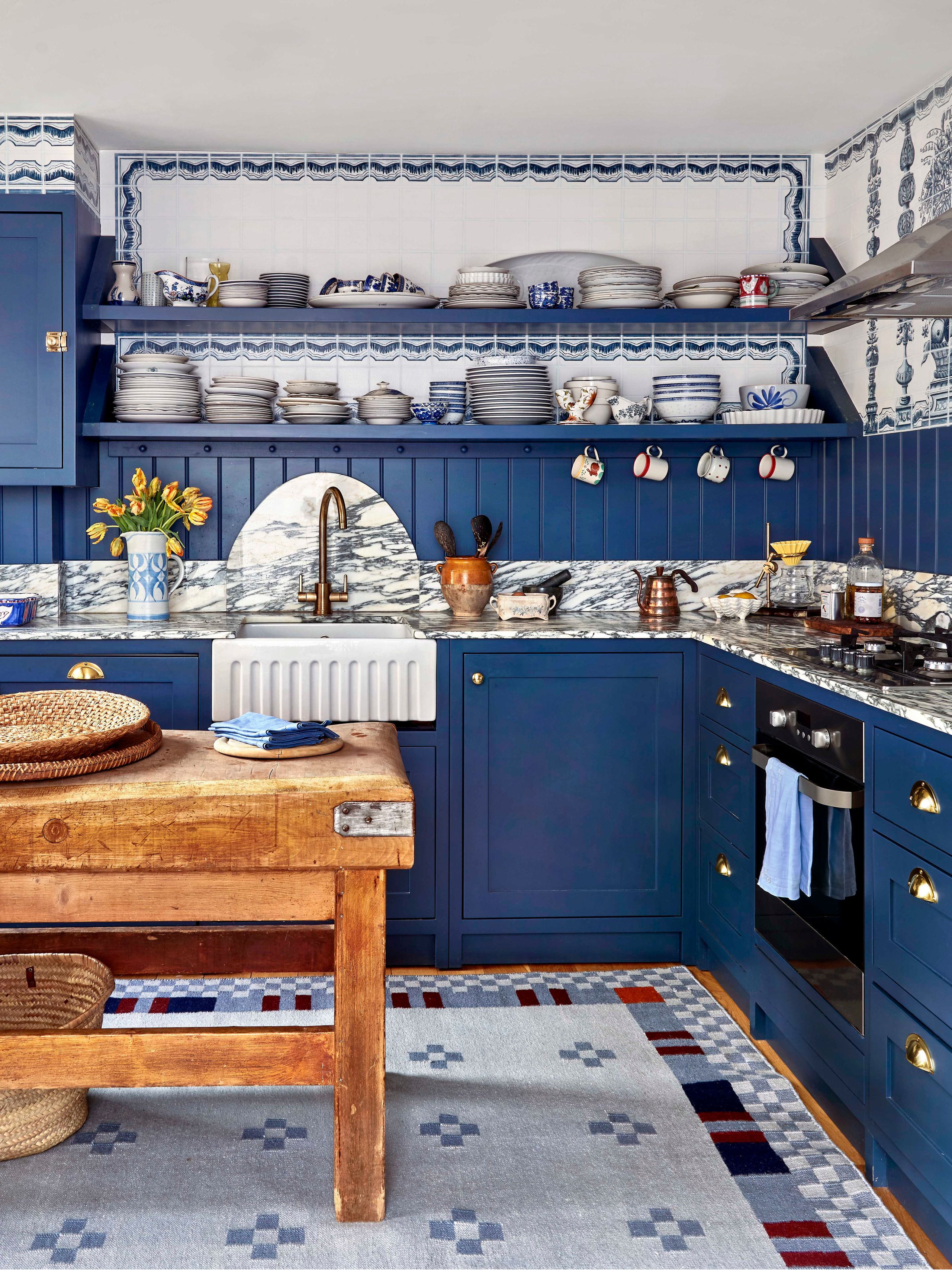 Image may contain: Indoors, Interior Design, Kitchen, Home Decor, Sink, Sink Faucet, Desk, Furniture, Table, Cup, and Rug