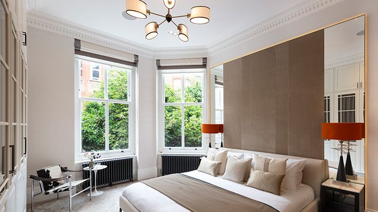 Image may contain: Lamp, Indoors, Interior Design, Bed, Furniture, Chair, Desk, Table, Home Decor, Chandelier, and Window