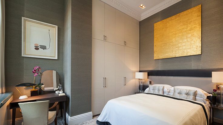 Image may contain: Corner, Chair, Furniture, Lamp, Indoors, Interior Design, Desk, Table, Bed, Home Decor, Art, and Painting