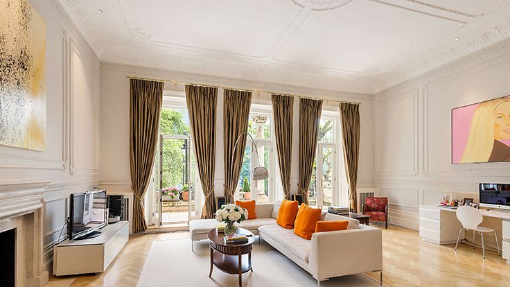 Image may contain: Home Decor, Chair, Furniture, Plant, Rug, Architecture, Building, Indoors, Living Room, Room, and Adult