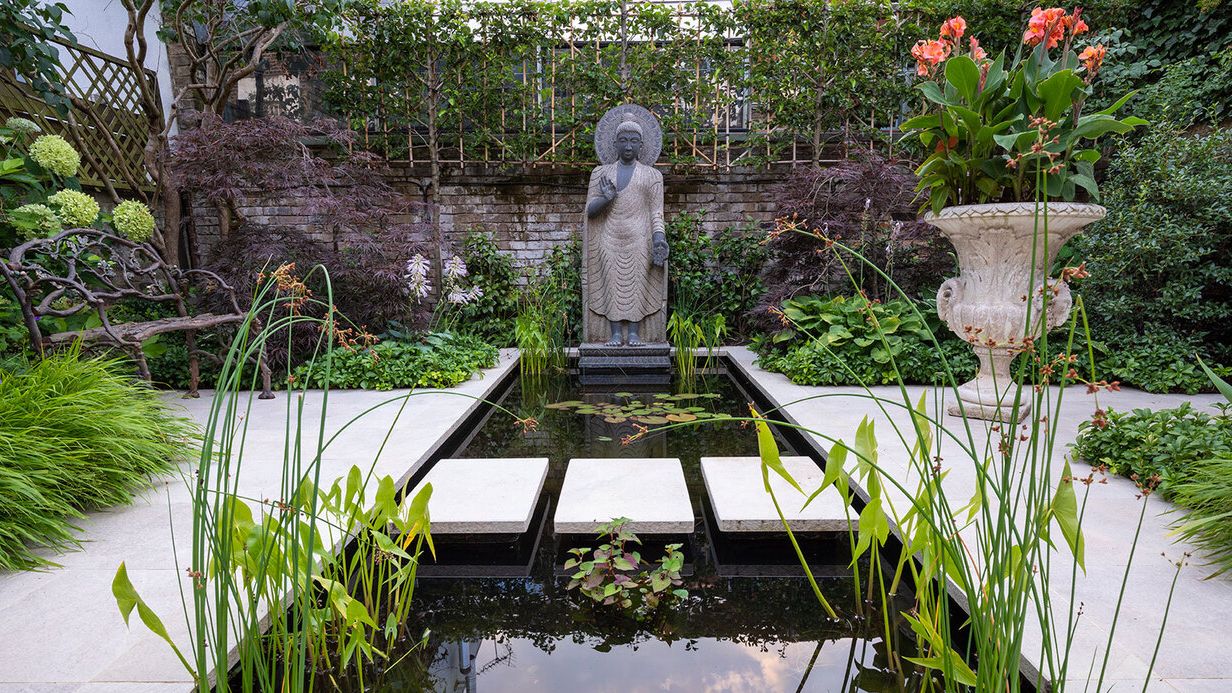 Image may contain: Nature, Outdoors, Pond, Water, Garden, Backyard, Yard, Person, Grass, Plant, Clothing, and Glove