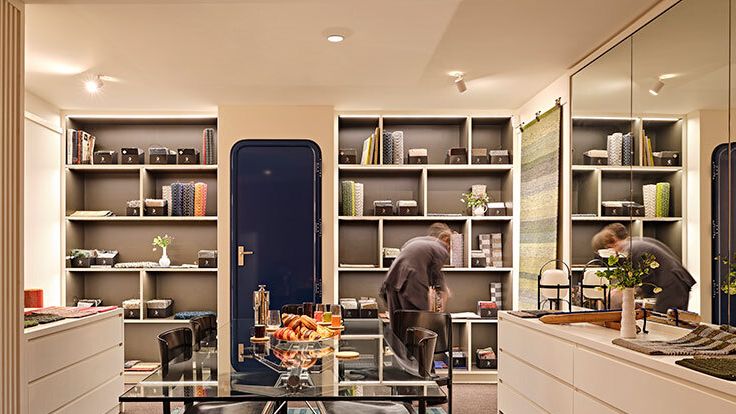 Image may contain: Home Decor, Rug, Chair, Furniture, Adult, Person, Indoors, Kitchen, Shelf, Interior Design, and Plant