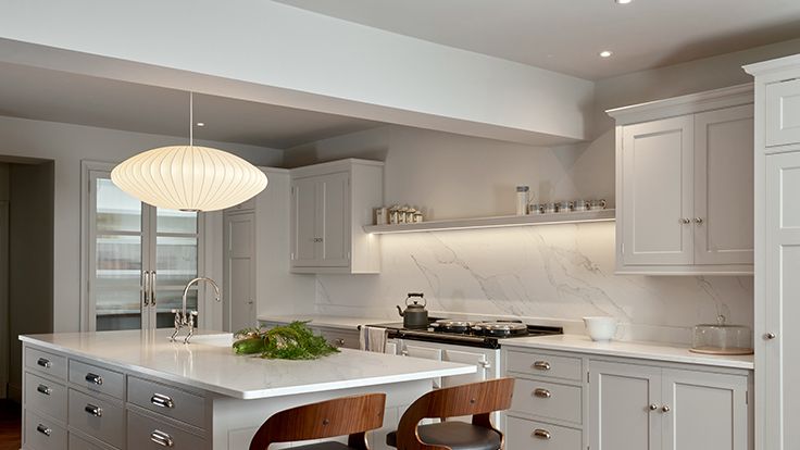 Image may contain: Indoors, Kitchen, Interior Design, Kitchen Island, Chair, Furniture, Lamp, Sink, and Sink Faucet