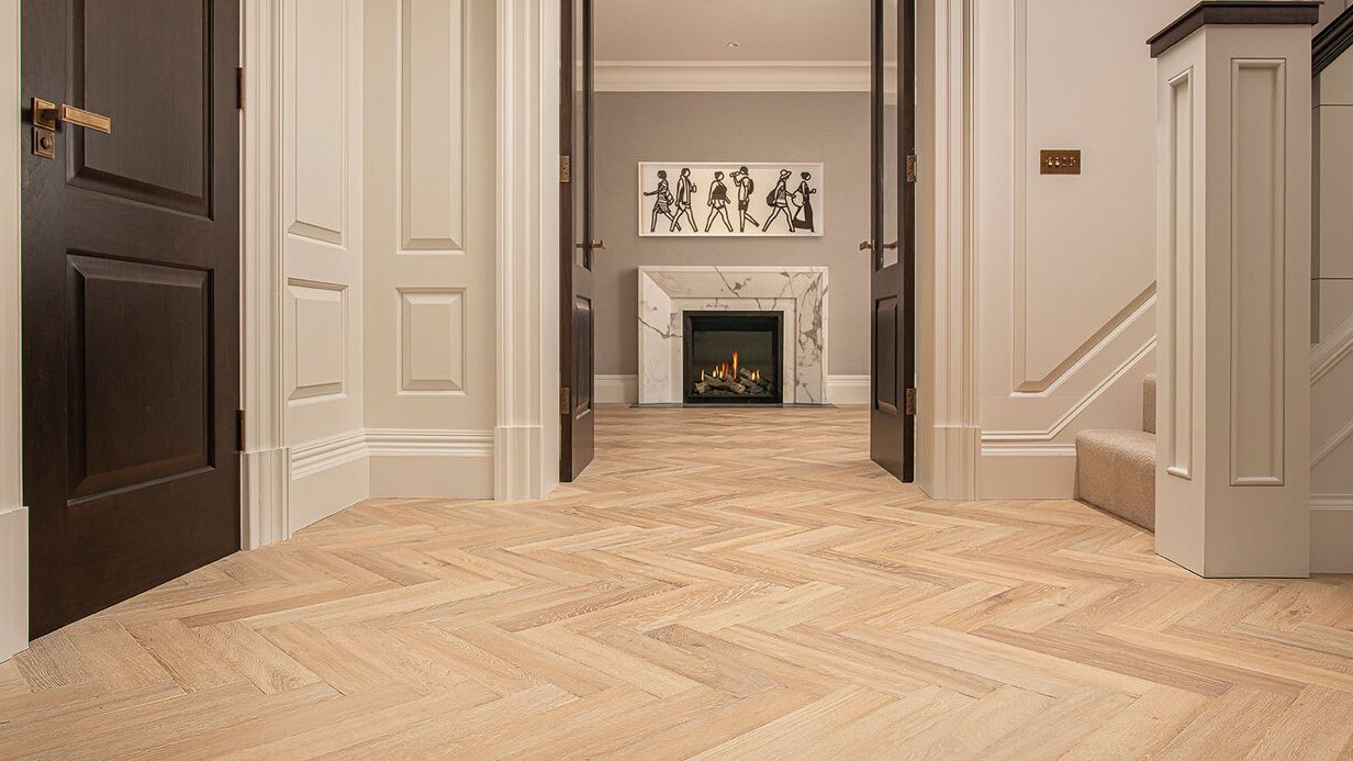 Image may contain: Floor, Indoors, Interior Design, Flooring, Fireplace, Wood, and Person