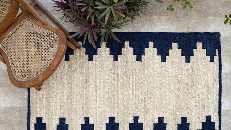 Image may contain: Home Decor, Rug, Chair, and Furniture