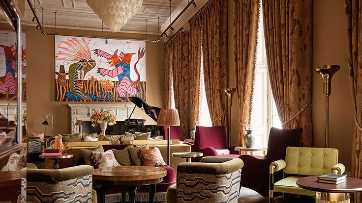 Image may contain: Home Decor, Book, Publication, Lamp, Chair, Furniture, Desk, Table, Rug, Couch, and Indoors