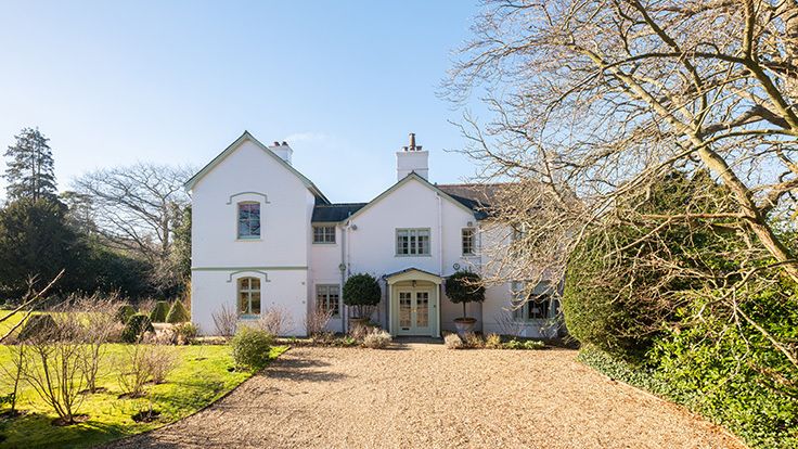 Image may contain: Architecture, Building, Housing, House, Plant, Outdoors, Driveway, Aerial View, and Manor