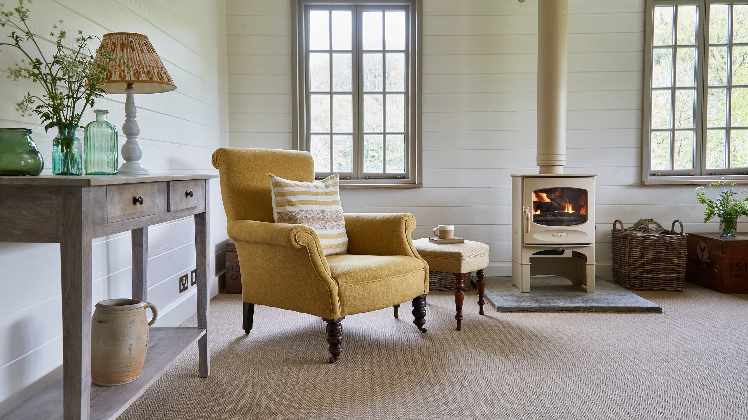 Image may contain: Lamp, Fireplace, Indoors, Chair, Furniture, Home Decor, Cup, Plant, Architecture, and Building