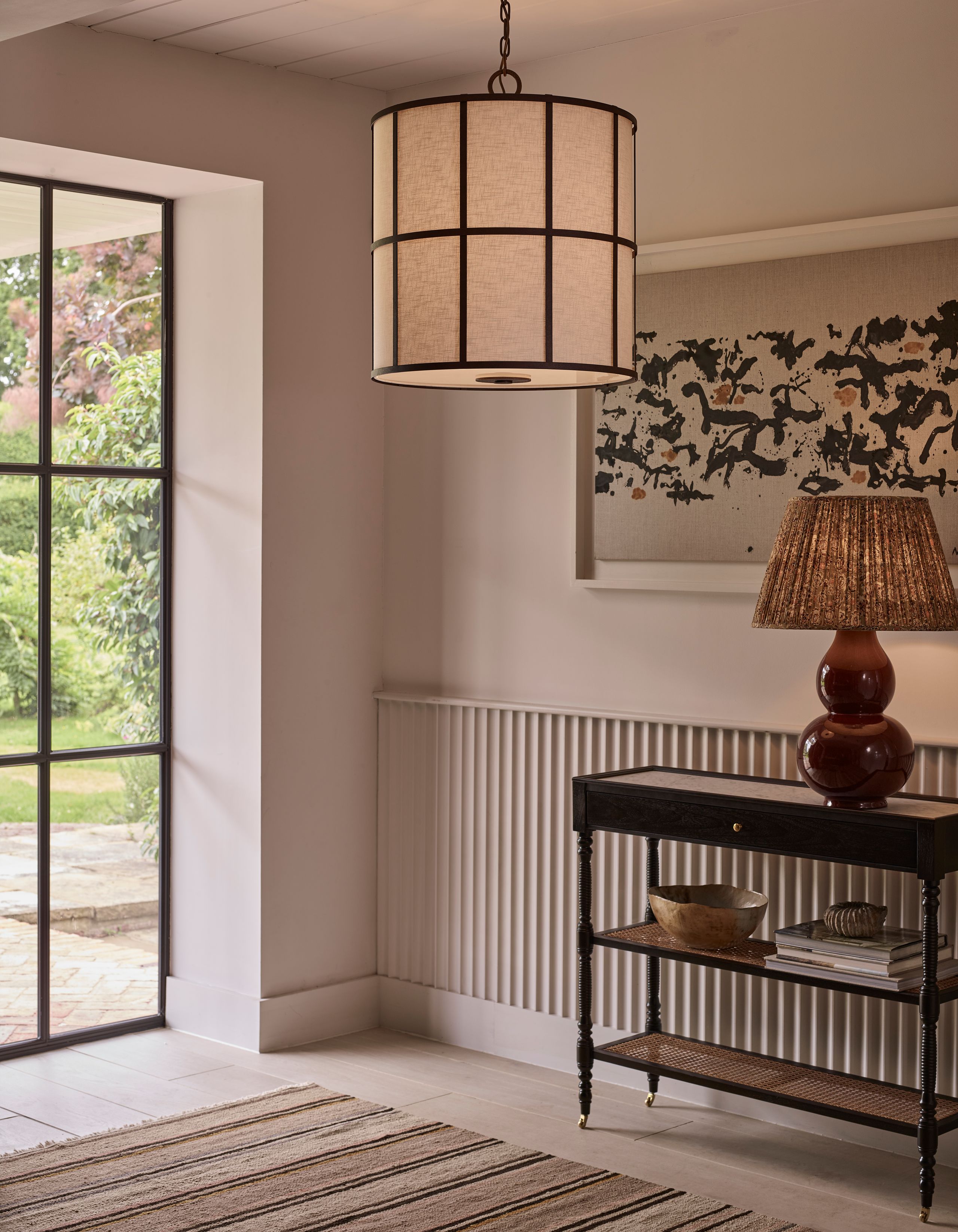 Image may contain: Lamp, Indoors, Interior Design, Home Decor, and Rug