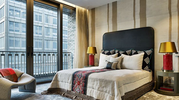 Image may contain: Lamp, Indoors, Interior Design, Bed, Furniture, Home Decor, Cushion, Chair, Table Lamp, Bedroom, and Room