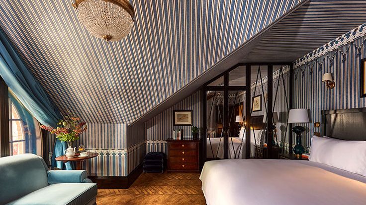 Image may contain: Lamp, Bed, Furniture, Couch, Plant, Indoors, Interior Design, Art, Painting, Desk, Table, and Home Decor