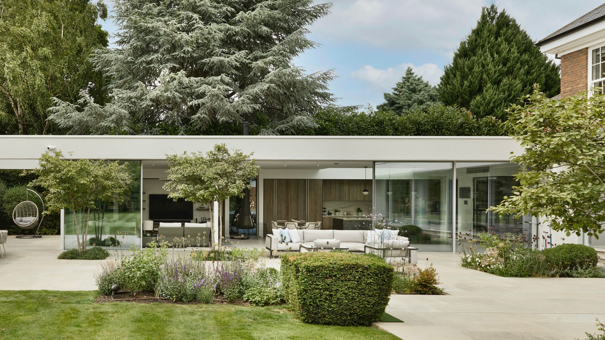 Image may contain: Grass, Plant, Architecture, Building, Housing, Door, House, Patio, Backyard, Nature, Outdoors, and Yard