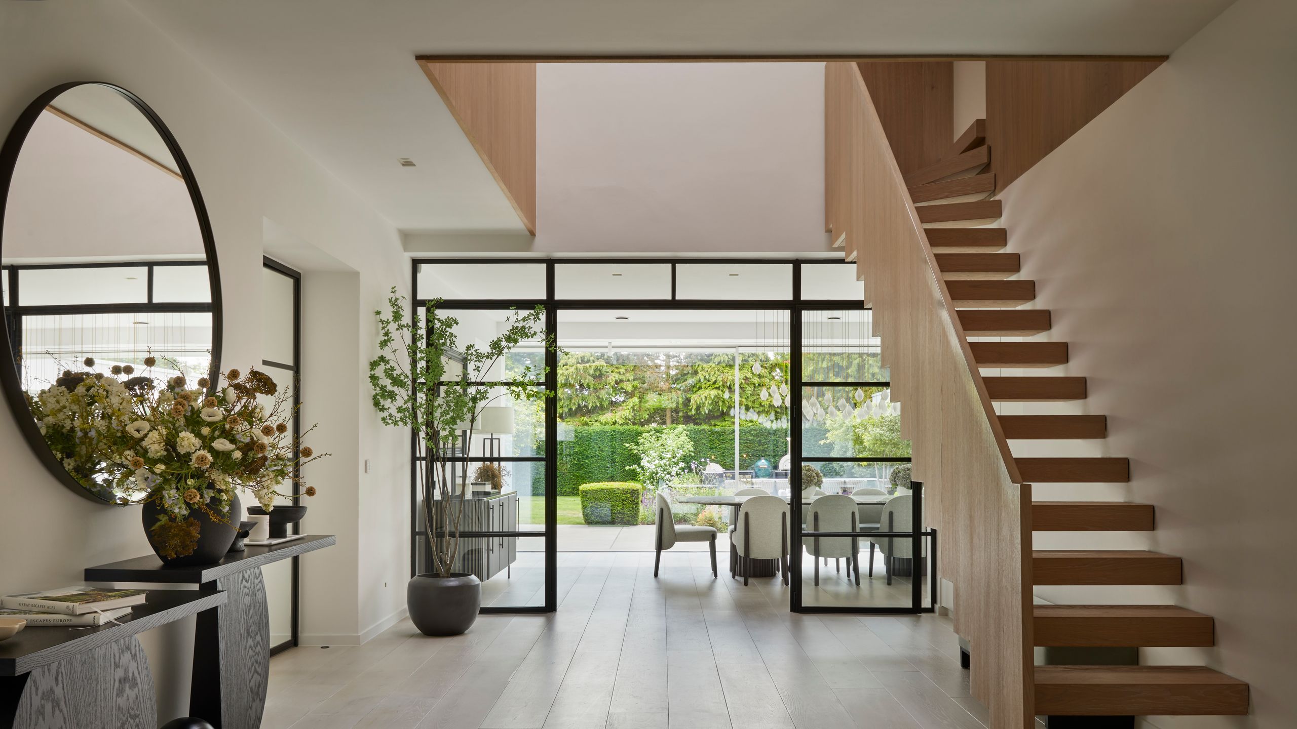 Image may contain: Architecture, Building, House, Housing, Staircase, Foyer, Indoors, Plant, Chair, Furniture, and Floor