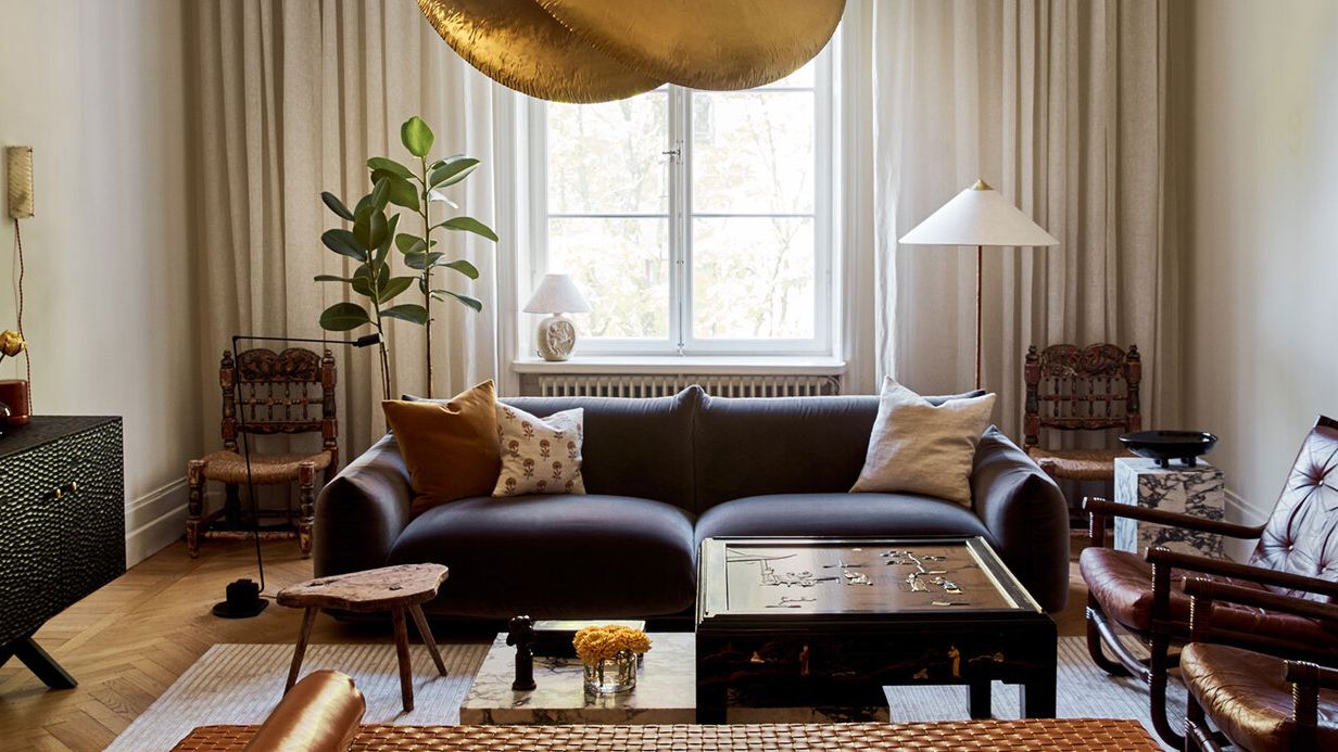 Image may contain: Home Decor, Lamp, Couch, Furniture, Chair, Table, Architecture, Building, Indoors, Living Room, and Room