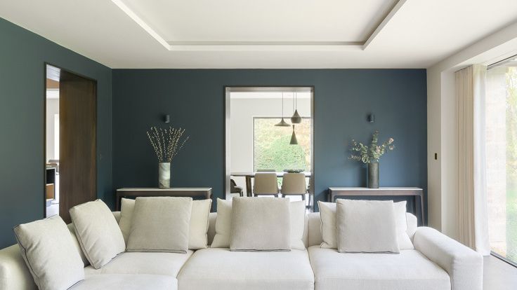 Image may contain: Couch, Furniture, Architecture, Building, Indoors, Living Room, Room, Home Decor, Cushion, Table, and Lamp