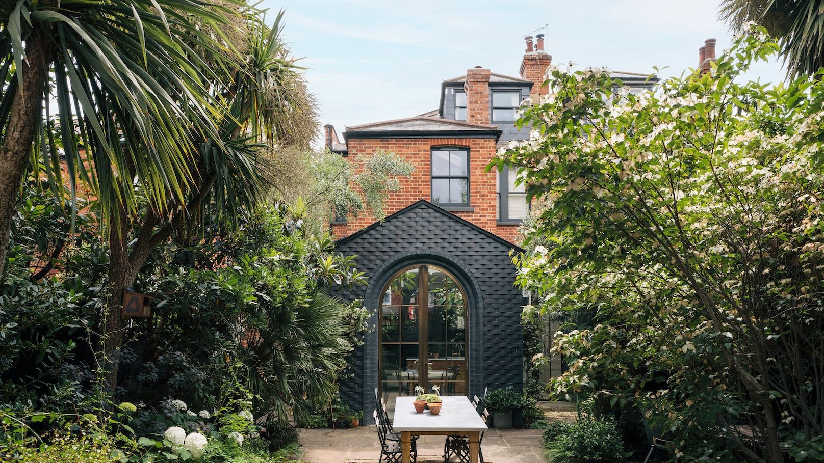 Image may contain: Architecture, Building, Cottage, House, Housing, Villa, Garden, Nature, Outdoors, Plant, and Chair