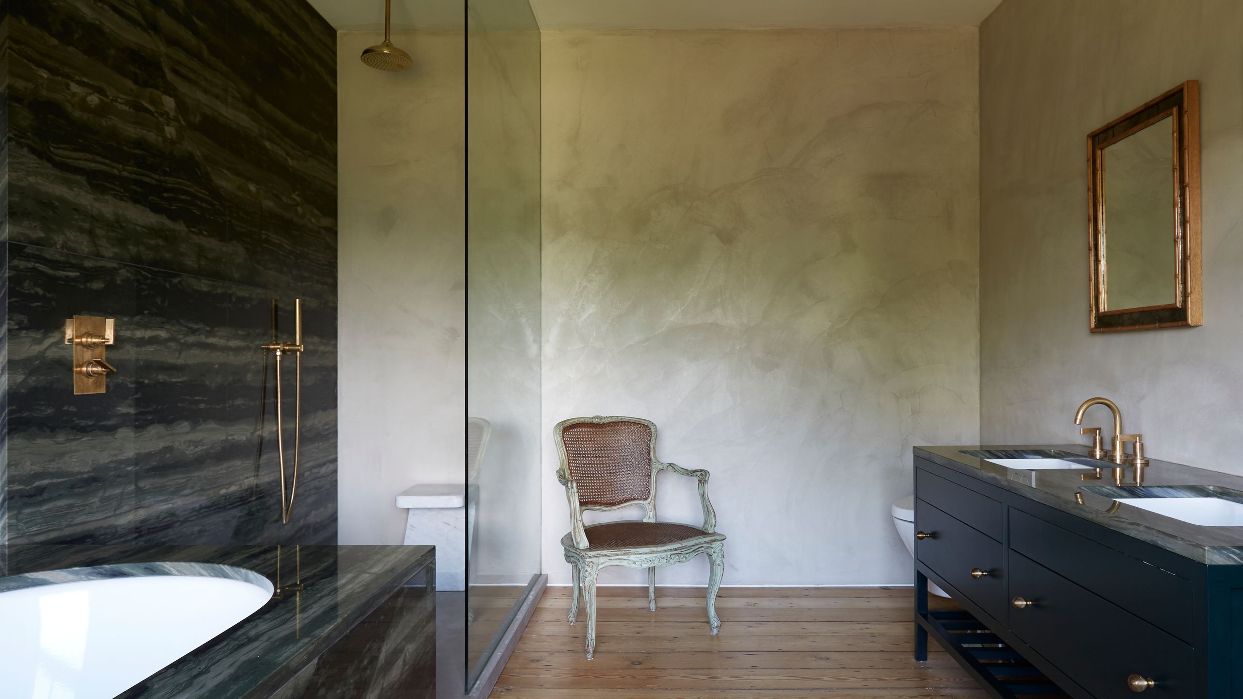 Image may contain: Indoors, Interior Design, Chair, Furniture, Bathing, Sink, Sink Faucet, Lamp, Floor, Wood, and Tub