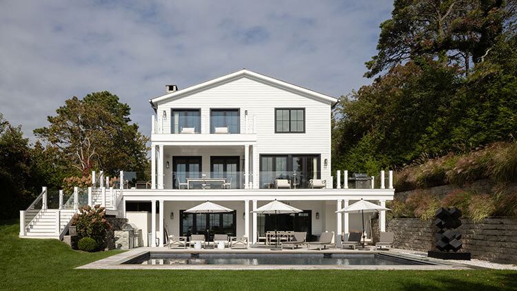 Image may contain: Architecture, Building, Housing, House, Villa, Chair, Furniture, Grass, Plant, Water, and Waterfront