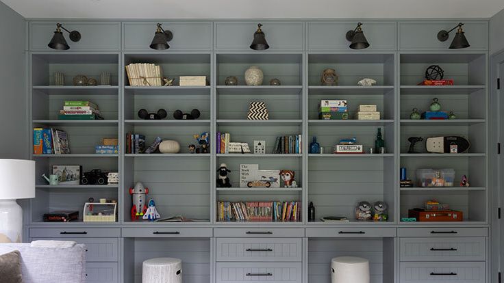 Image may contain: Furniture, Lamp, Bookcase, Couch, Toy, Home Decor, Rug, Cup, Box, Indoors, and Interior Design