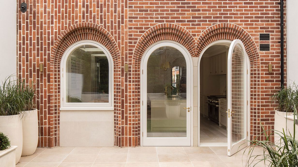 Image may contain: Door, Plant, Brick, Arch, Architecture, Building, Housing, and House
