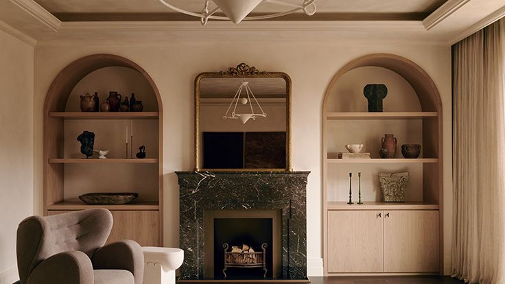 Image may contain: Fireplace, Indoors, Interior Design, Chair, Furniture, Hearth, Home Decor, Architecture, and Building